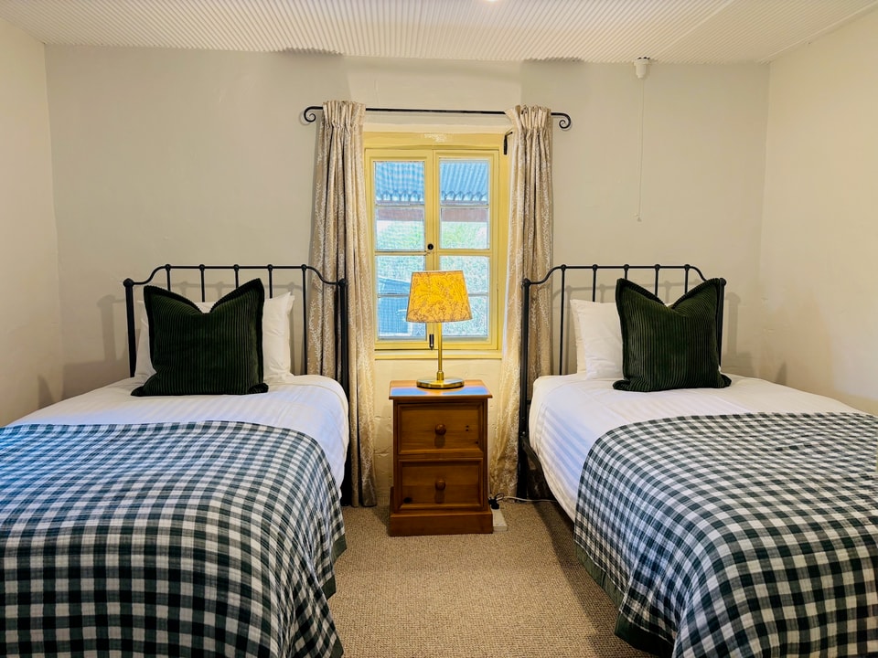 Image of the second bedroom (two king single beds) in the Flaxman cottage.